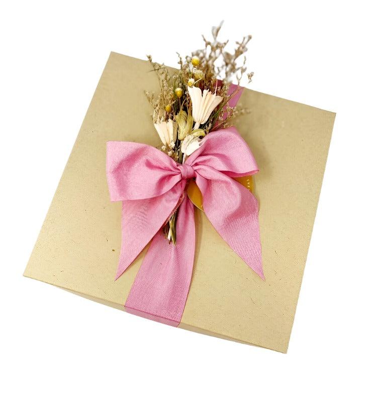 kraft gift box tied with pink ribbon