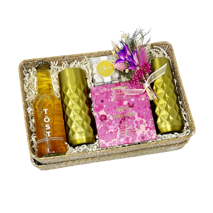 Poppin' Bottles gift box with non-alcoholic sparkling beverage, a set of gold-finished insulated champagne flutes, red berries chocolate bar, champagne-flavored gummies, handmade dried floral bundle and reusable woven gift basket.