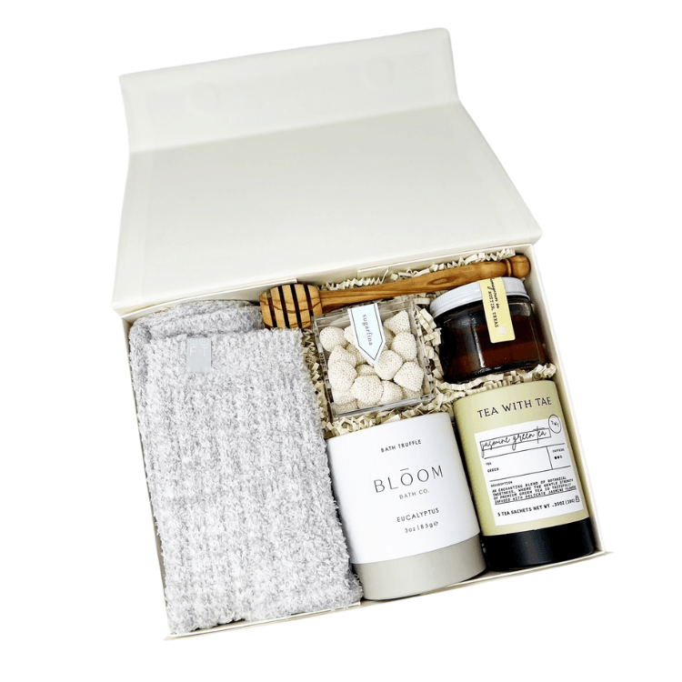 Treat Yourself Gift Box with cozy socks, honey, drizzle stick, green tea, eucalyptus bath bomb and champagne gummies.