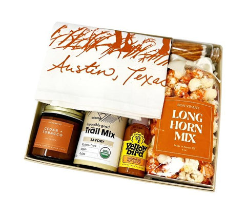 We Love Austin themed gift box with longhorn mix popcorn, longhorn tea towel, cedar & tobacco candle, savory trail mix, mini yellowbird habanero hot sauce