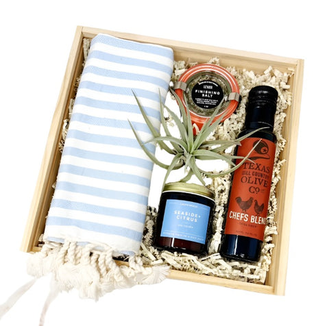 welcome home housewarming gift box with striped hand towel, extra virgin olive oil, herbed finishing salt, seaside + citrus soy candle, air plant