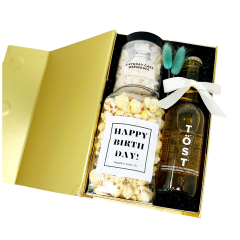 birthday gift box with birthday cake popcorn, birthday cake mini meringues and a non-alcoholic sparkling beverage