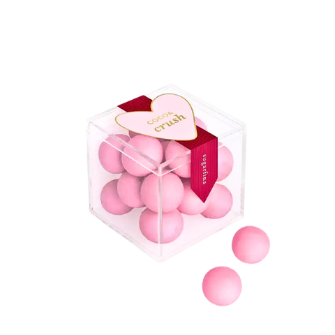 A 2.6 oz container filled with bite sized brownie bites coated in pastel pink candy shells. Perfect for anyone!
