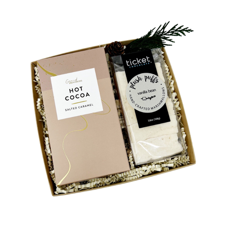 Gift set with hot cocoa and marshmallows in a decorative box on a white background