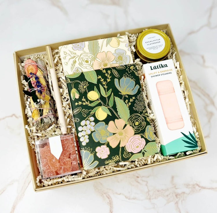 Fresh Start gift box with floral notebooks, pen, mini candle, sage smudge stick, shower steamers and sparkling rose gummies.