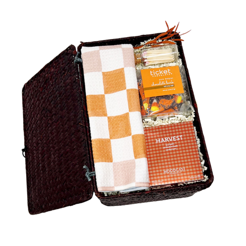fall themed housewarming gift with tea towel, pumpkin candle, matches and fall candy chocolate bark