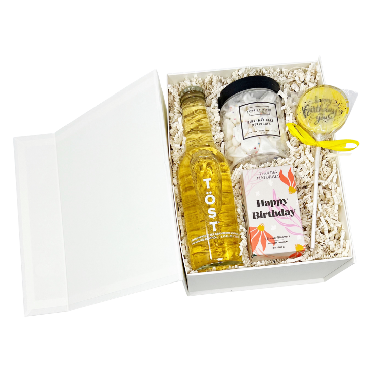 Happy Birthday themed gift box with sparkling beverage, birthday cake meringue bites, birthday shower steamers, a star sparkler and birthday cake lollipop