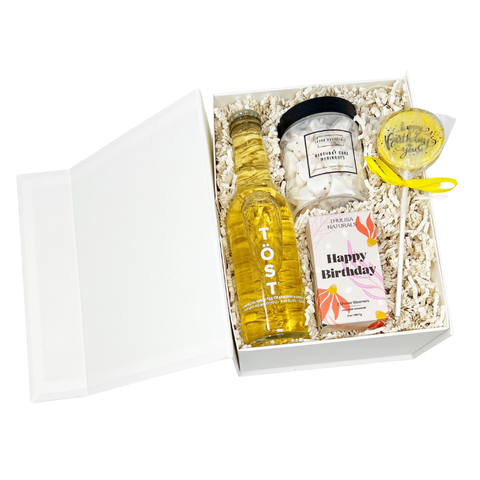 Happy Birthday themed gift box with sparkling beverage, birthday cake meringue bites, birthday shower steamers, a star sparkler and birthday cake lollipop