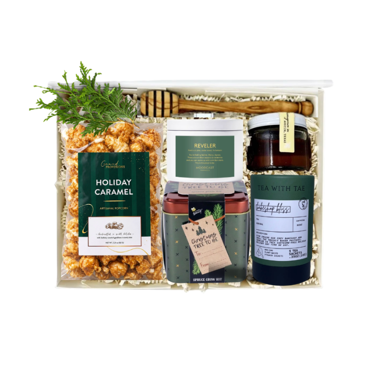 holiday gift box with caramel popcorn, holiday candle, spruce grow kit, holiday tea and raw honey