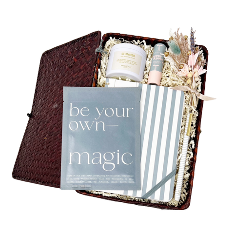 gift basket with 'be your own magic' facial sheet mask, striped notebook, pen, 'Stunner' travel candle, lip balm and handmade dried floral bundle. Perfect for gifts for her, birthday gifts, new job gift, new beginnings, new year's goals.