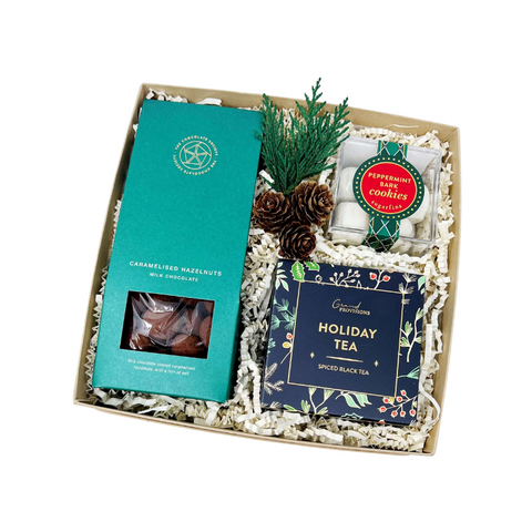 Noel holiday gift box with caramelized chocolate covered hazelnuts, holiday tea and peppermint bark cookie bites