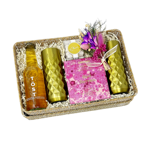 Poppin' Bottles gift box with non-alcoholic sparkling beverage, a set of gold-finished insulated champagne flutes, red berries chocolate bar, champagne-flavored gummies, handmade dried floral bundle and reusable woven gift basket.