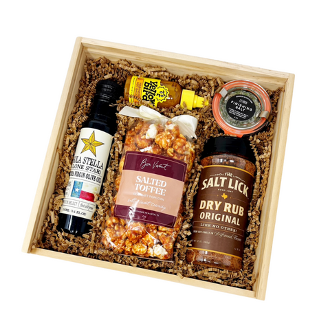 Taste of Austin gift box with salt lick bbq rub, hill country olive oil, lenoir finishing salt, salted toffee popcorn and yellowbird habanero hot sauce.