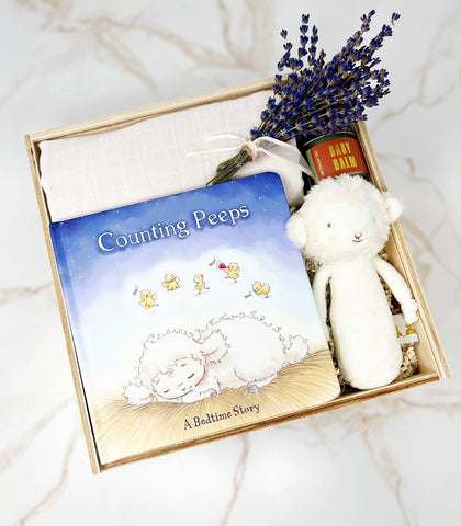 newborn gift box gender neutral swaddle, counting peeps book, soft lamb rattle, baby balm and lavender