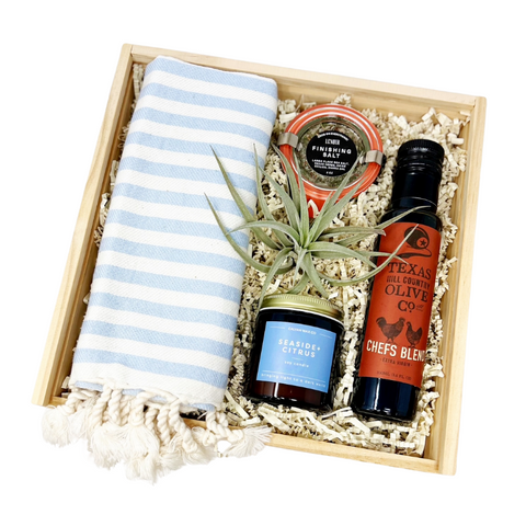 welcome home housewarming gift box with striped kitchen towel, finishing salt, seaside citrus candle olive oil and small air plant