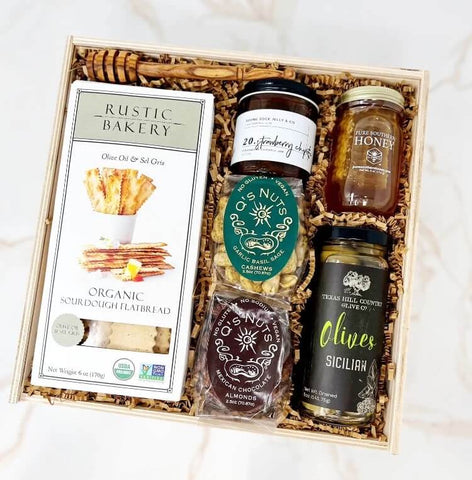 Snack Board Gift Box with sourdough flatbread, strawberry chipotle jam, honey with honeycomb, honey stick, sicilian olives, garlic basil sage cashews, mexican chocolate almonds