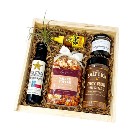 Taste of Austin gift with salt lick bbq rub, olive oil, popcorn, yellowbird habanero hot sauce and strawberry chipotle jam.