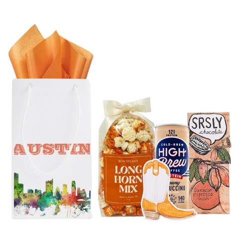 welcome to austin gift bag with local pocpcorn, high brew coffee, chocolate bar and cowboy boot magnet